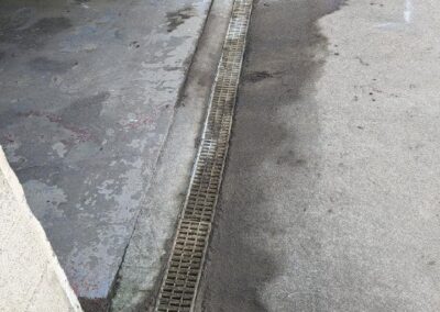 newly installed drain next to garage door
